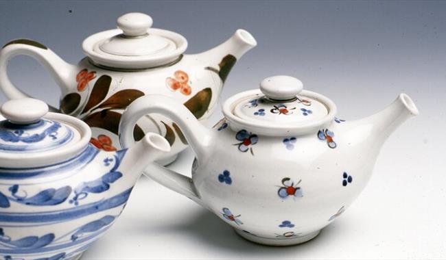 Three hand painted tea pots