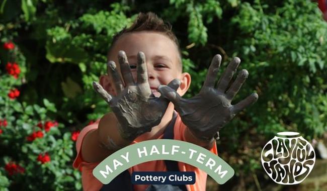 boy with clay covered hands