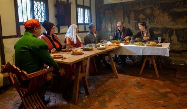 Medieval meal table with guests