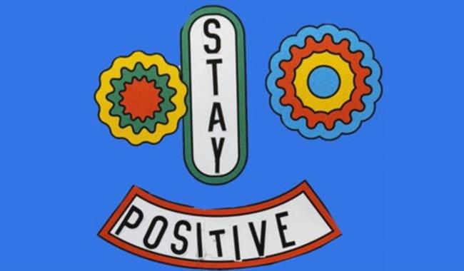 Community of kindness poster reading Stay Positive in the shape of a face