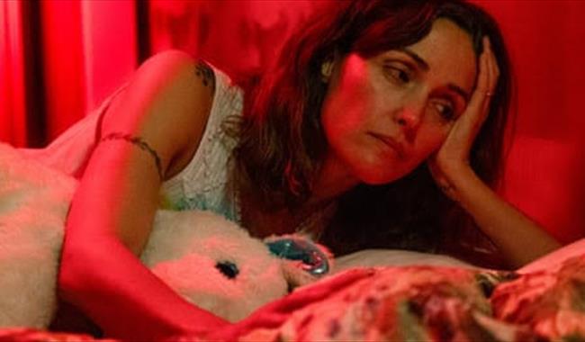 Woman in bed looking sad
