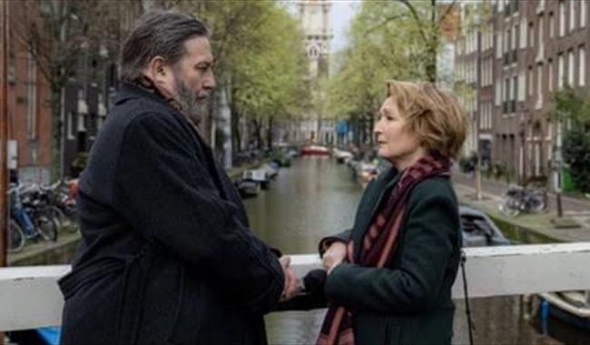 Actors Lesley Manville and Ciaran Hinds on a bridge  in Amsterdam