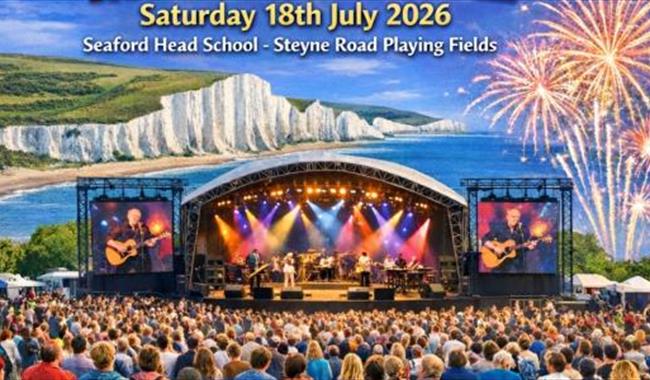 Festival stage with crowds enjoying the music, with fireworks in the sky