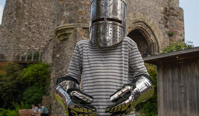 Child wearing armoured helmet and gloves at Lewes Castle