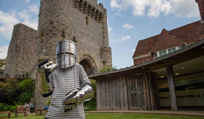 Child wearing armour at Lewes Castle.