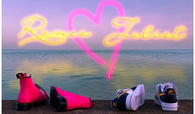 Postcard image - a girl's and a boy's shoes on the shore