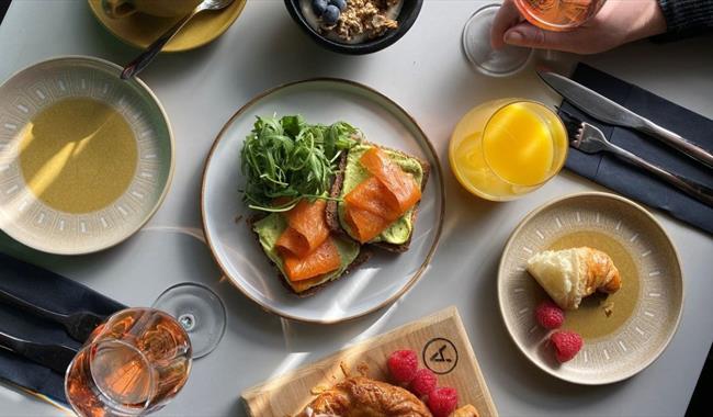 Breakfast dishes with glass of rose wine