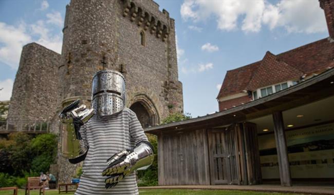 Young person dressed in armour at Lewes Castle