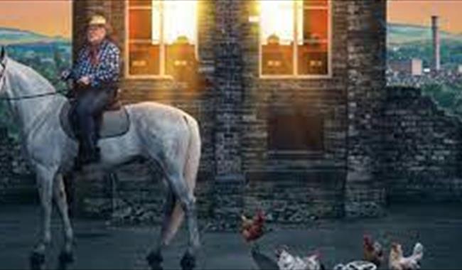 Man on a horse in front of a building