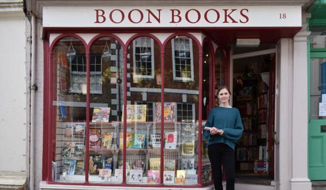 Boon Books shopkeeper in doorway