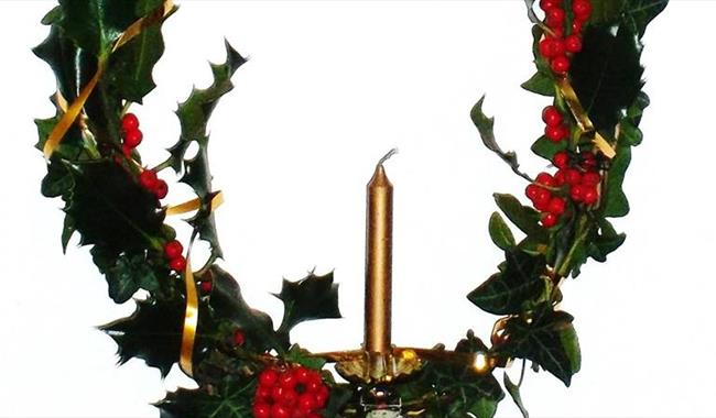 Christmas holly wreath with candle