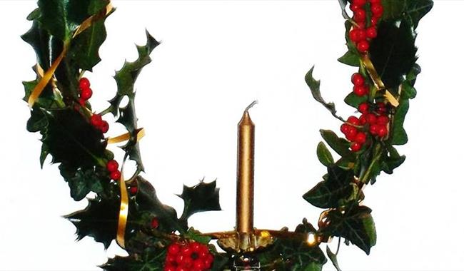 Christmas holly wreath with candle