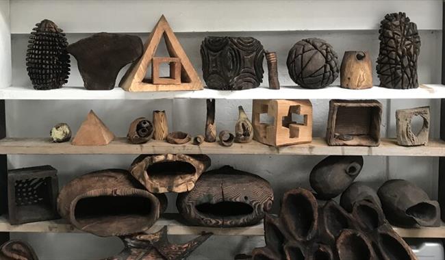 Wooden sculptures and objects on shelves