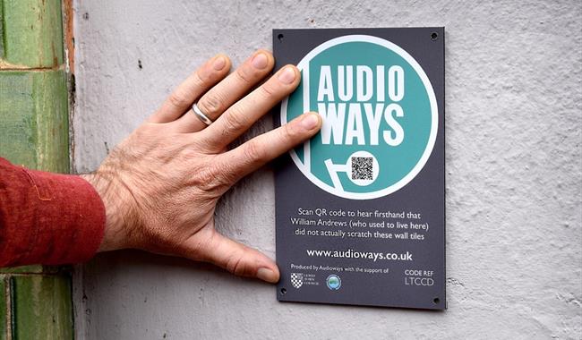 Audioways sign, person scanning QR code