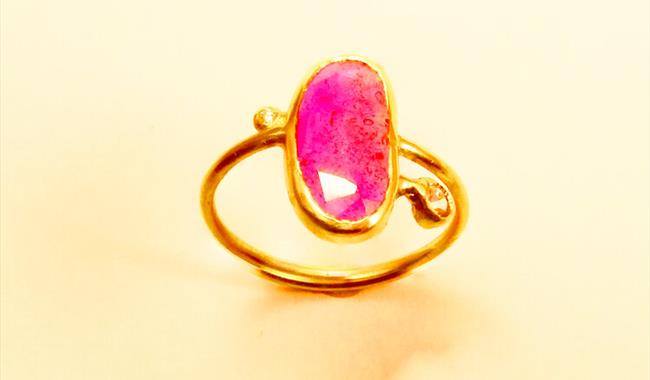 Gold ring with bright pink stone