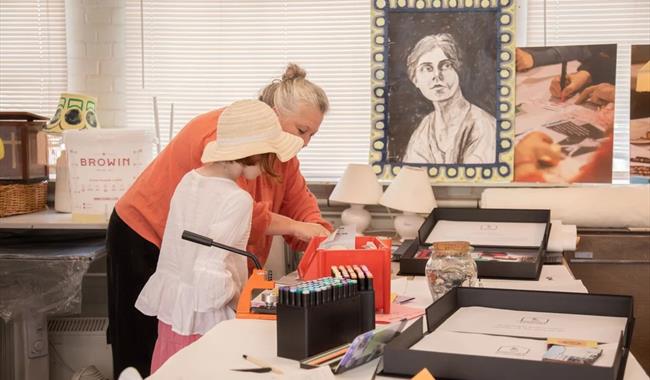 Adult and child creating artwork together