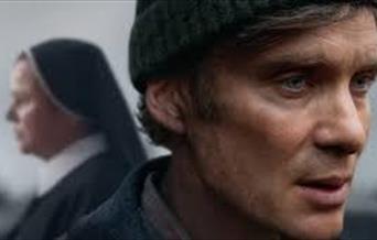 Photo of actor Cillian Murphy with a nun in the background