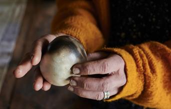 Pair of hands holding a ball of clay
