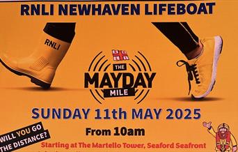 Pair of feet wearing one RNLI welly and one trainer