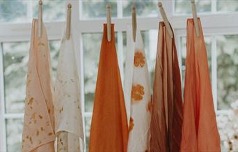 hand dyed cloths drying in the window