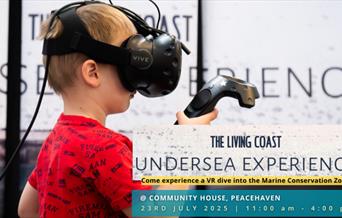 child experimenting with the Living Coast Undersea Experience