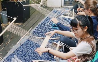 Working on a backstrap loom