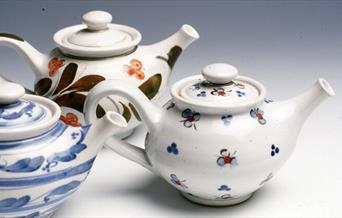 Three hand painted tea pots