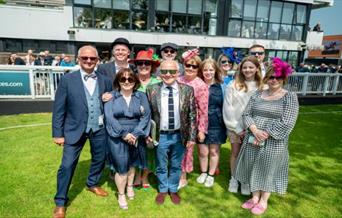 Group of racegoers in the sunshine at Plumpton