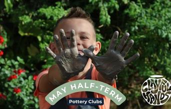 boy with clay covered hands