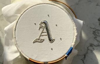 Gold embroidery in embroidery frame