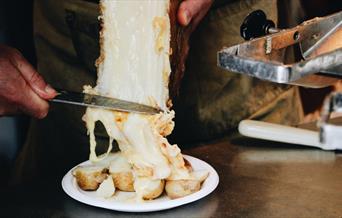 Raclette cheese on potatoes.