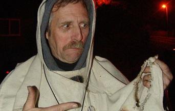 Folk musician Doc Rowe dressed as a Bonfire priest