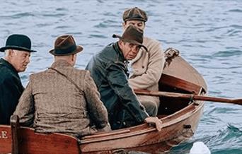 Photo taken from film featuring 4 men in a boat