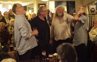 Folk group performing in pub setting