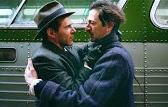 Characters embracing in The Brutalist.