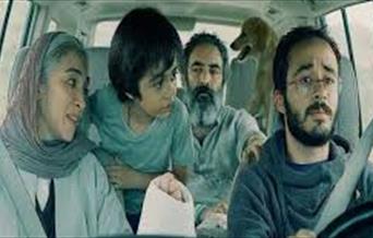 Family travelling in a car in Iran