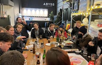 People enjoying a beer at Abyss Brewery