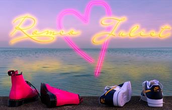 Postcard image - a girl's and a boy's shoes on the shore