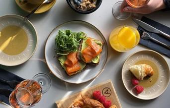 Breakfast dishes with glass of rose wine