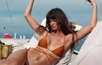 Bikini clad woman on a sun lounger