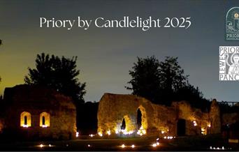 Photograph of Lewes Priory lit by candles