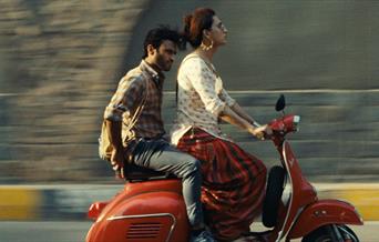 Stars from the Indian film Joyland riding a moped