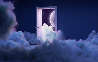 Photo of the moon peeping through an open door