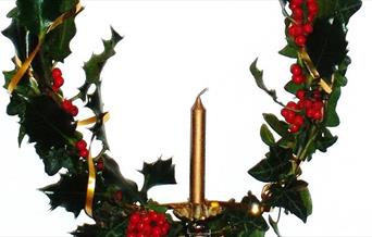 Christmas holly wreath with candle