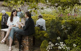 People sitting in the Charleston walled garden