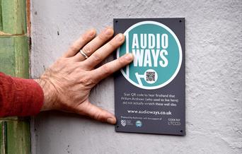 Audioways sign, person scanning QR code