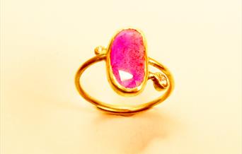 Gold ring with bright pink stone