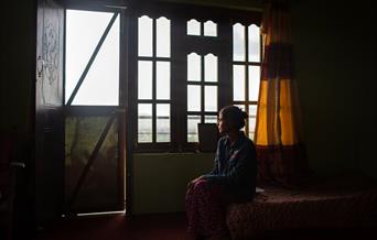 Woman looking out of window