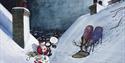 Father Christmas sharing a picnic with reindeer on the rooftops