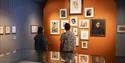Visitors looking at artworks